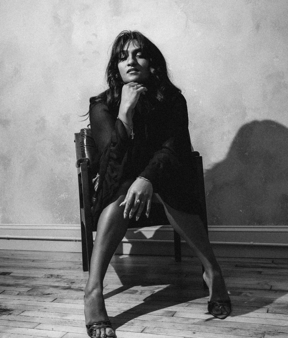Mashi J seated in soft studio light, looking away